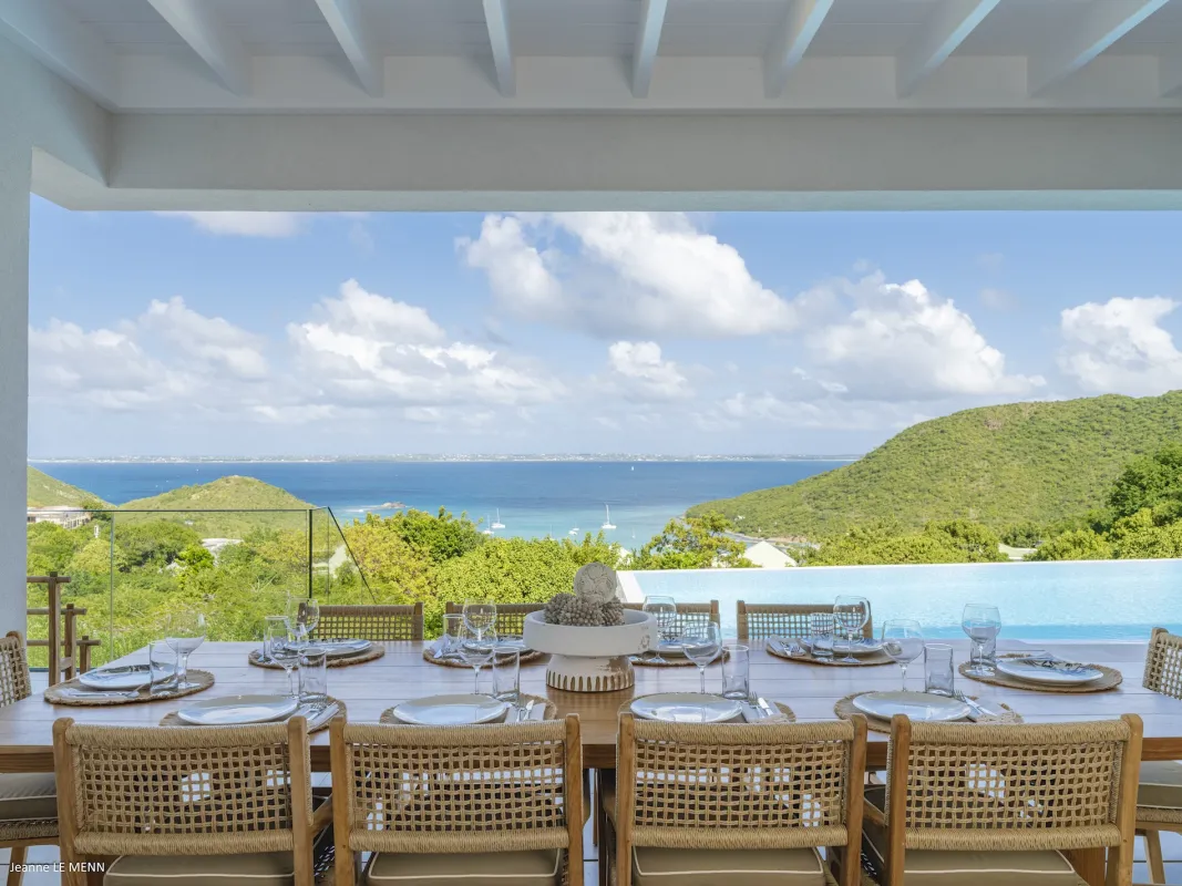 Villa Abaca: Covered terrace with a set dining table overlooking an infinity pool and the sea