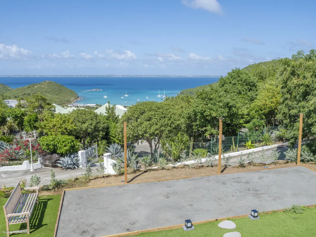Villa Abaca: Bocce court and wooden bench overlooking a tropical bay and sea