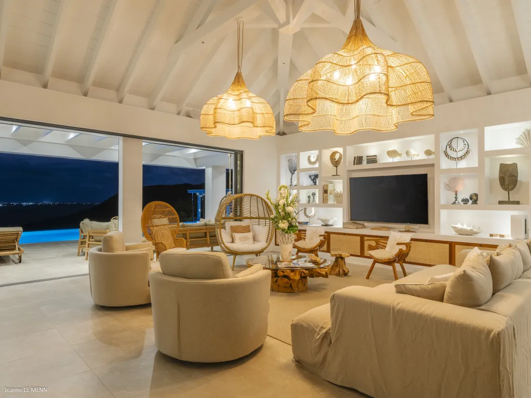 Villa Abaca: Living room with vaulted ceiling, large woven pendant lights, and open terrace doors