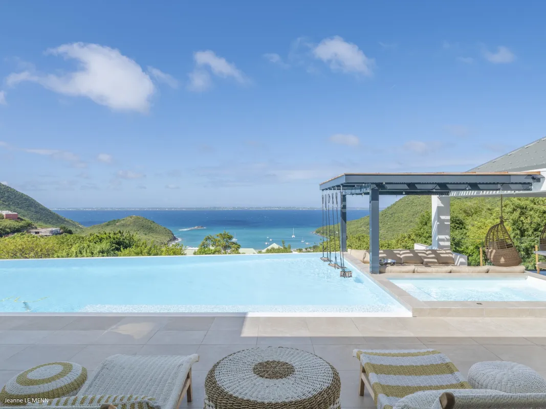 Villa Abaca: Infinity pool and sun terrace with loungers overlooking a bay and rolling hills