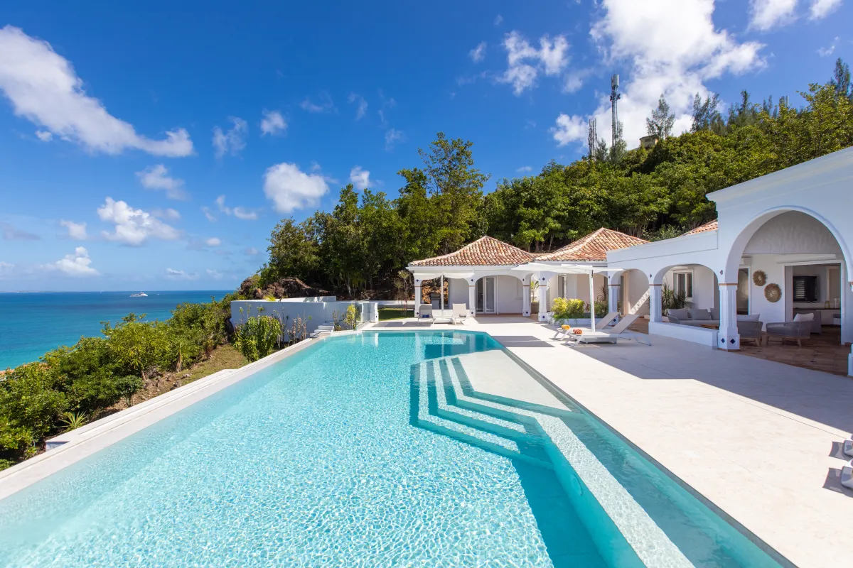 Villa Agama: Infinity pool and sun terrace overlooking the ocean beside a white villa