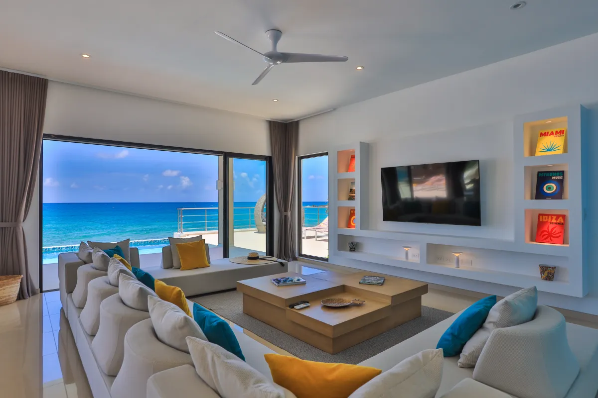 Villa Alma: Modern living room with sectional sofa and large sliding doors overlooking the sea