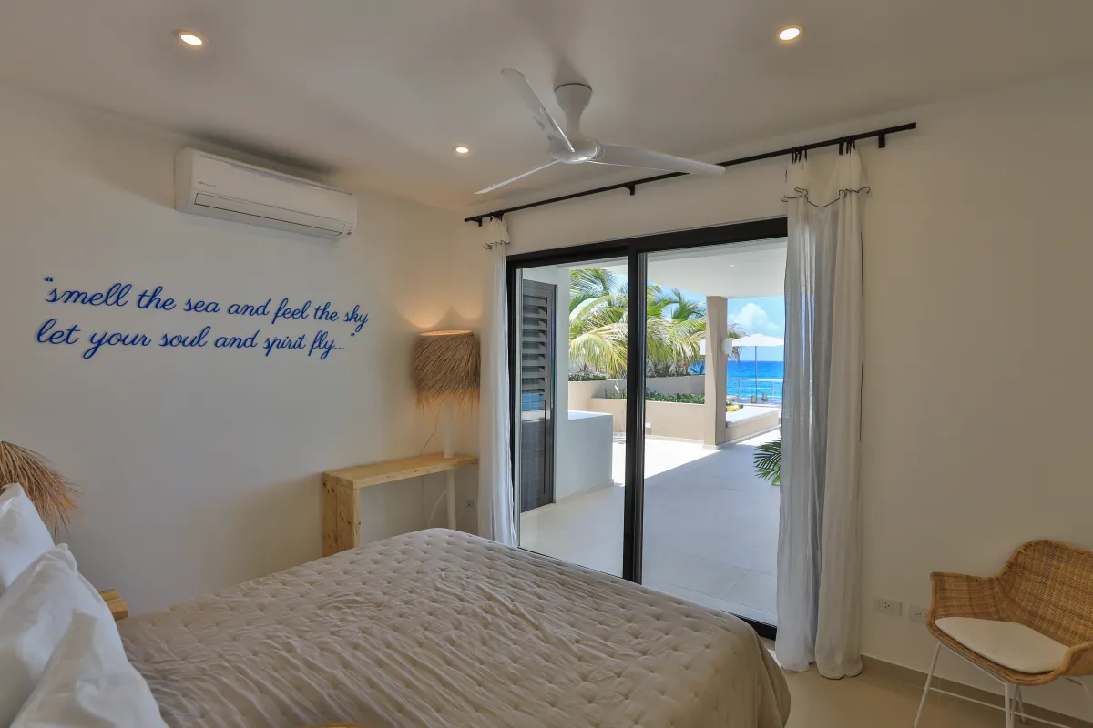 Villa Alma: Bedroom with sliding glass doors opening to a terrace with an ocean view