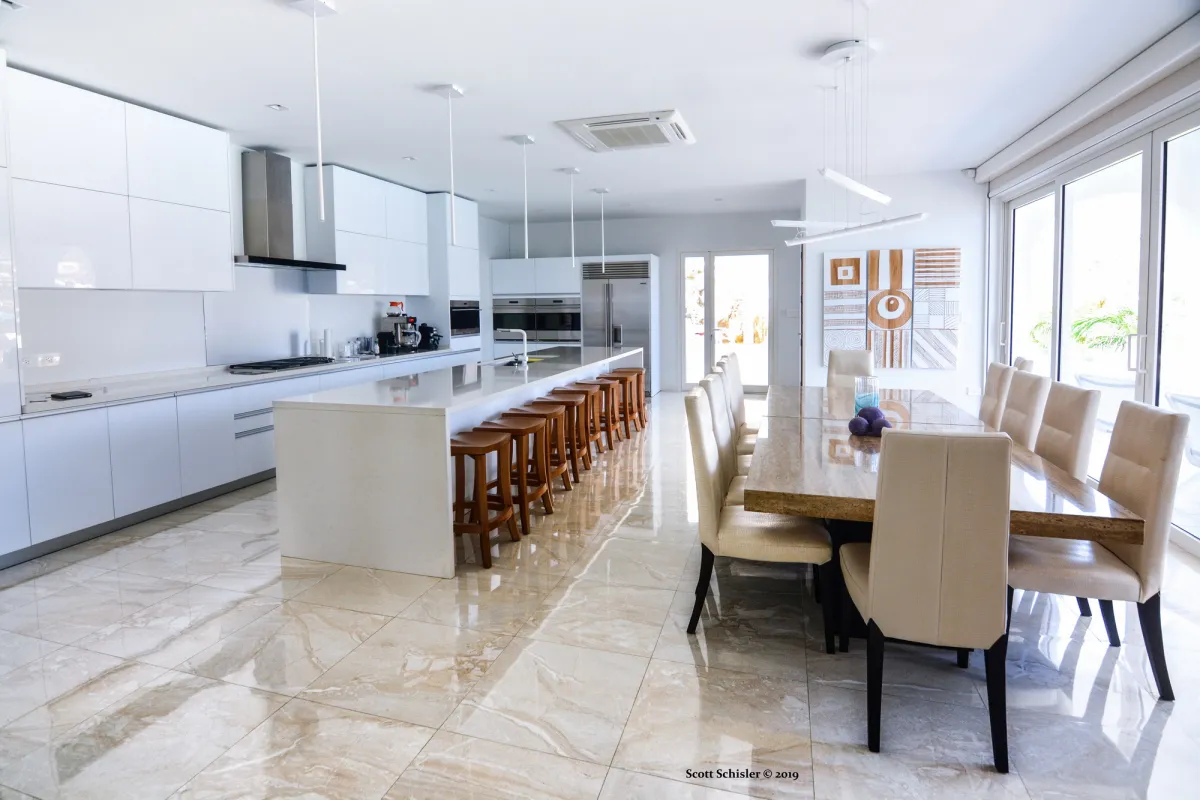 Villa Amalia: Modern open-concept kitchen with a large breakfast island and a long dining table
