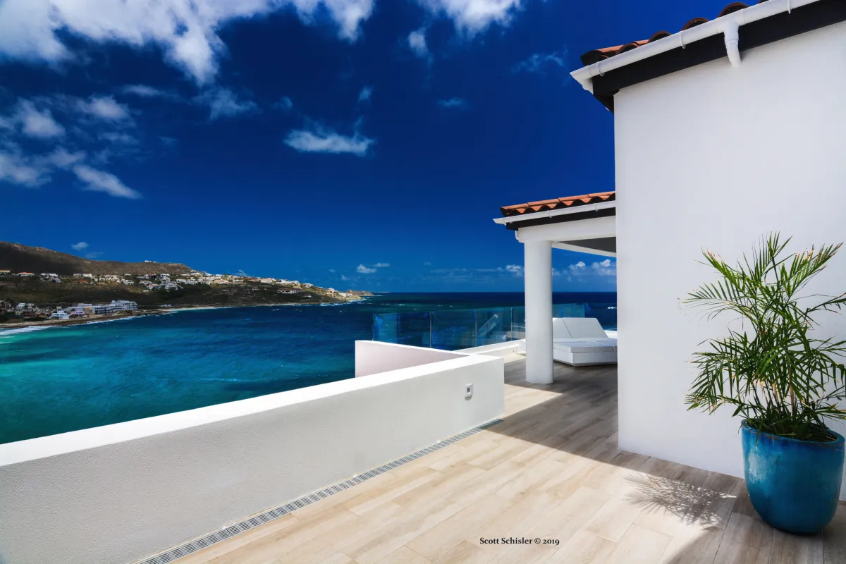 Villa Amalia: Outdoor terrace with white walls, potted plant, and expansive ocean views
