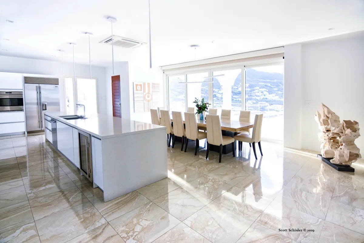 Villa Amalia: Open kitchen and dining area with a long island, dining table, and mountain views