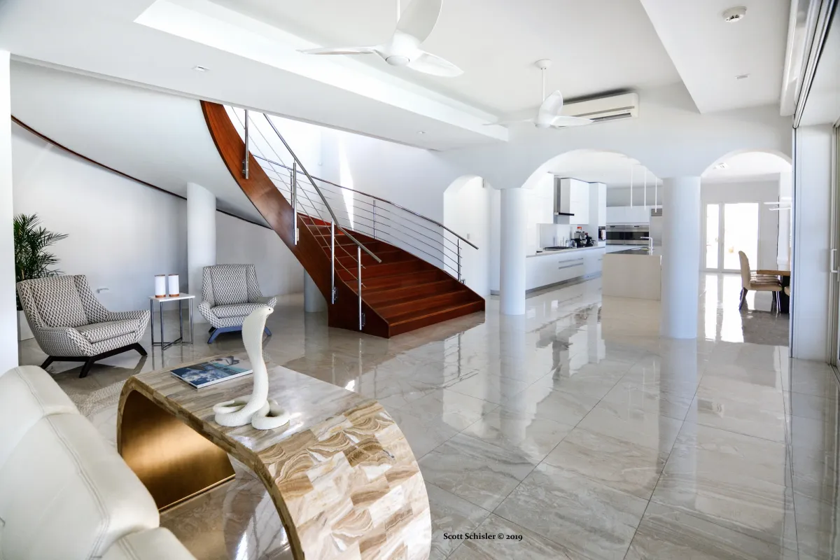 Villa Amalia: Spacious open living area with curved wooden staircase and polished tile flooring