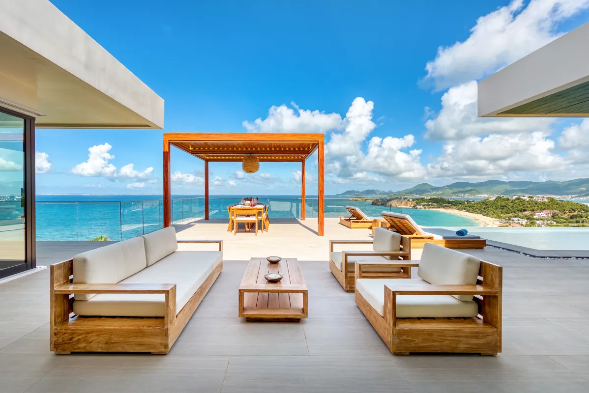 Villa Amandara: Terrace with wooden outdoor seating and dining pergola overlooking the ocean and coastline