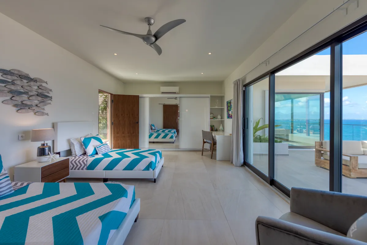 Villa Amandara: Bedroom with two twin beds and sliding glass doors opening to a sea-view terrace