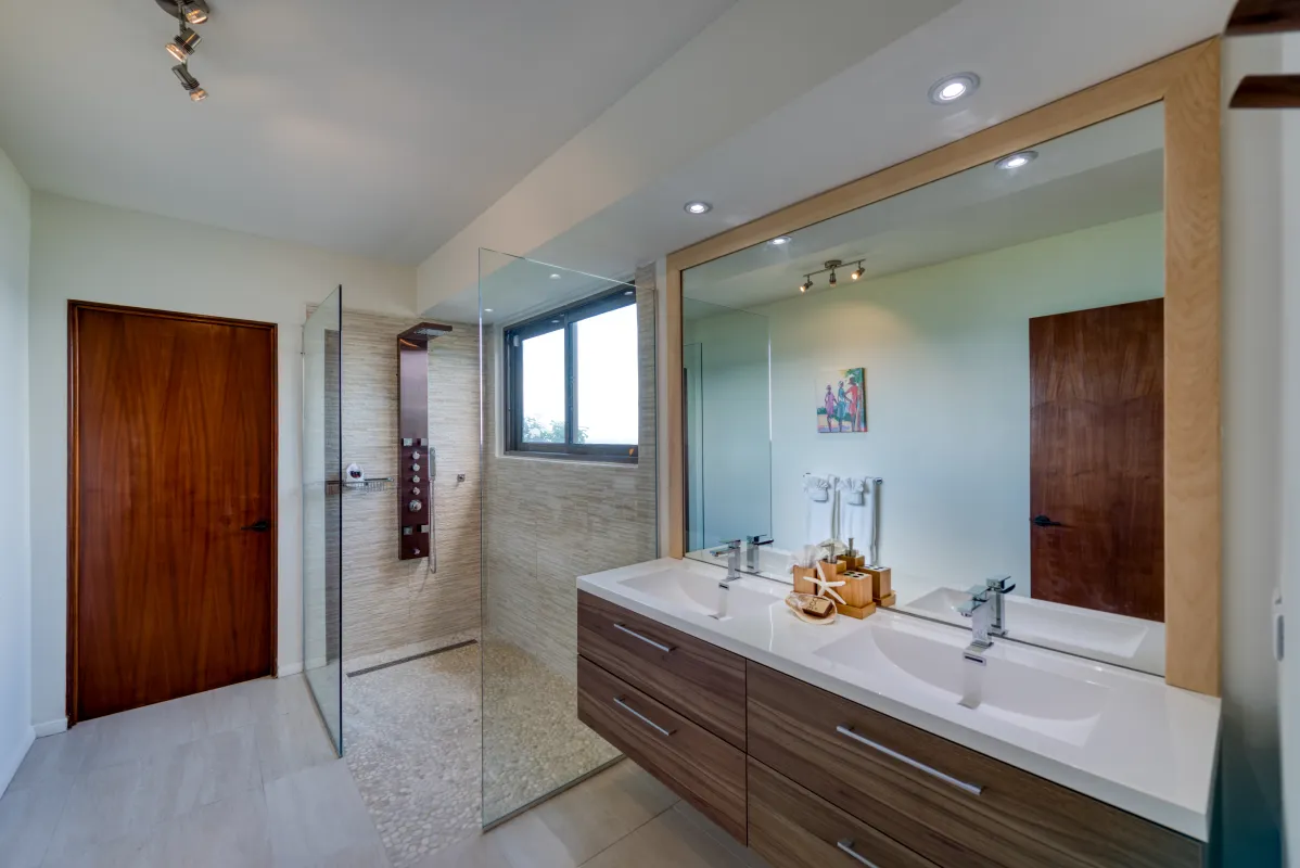 Villa Amandara: Bathroom with a double sink vanity, large mirror, and glass walk-in shower