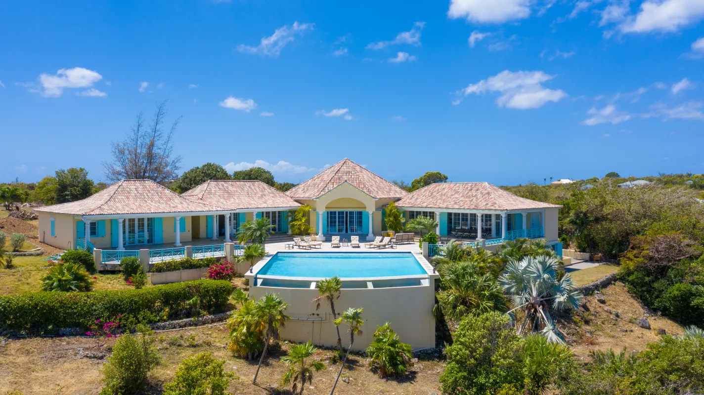 Villa Amber: Villa exterior featuring a swimming pool, sun deck, and lush tropical landscape