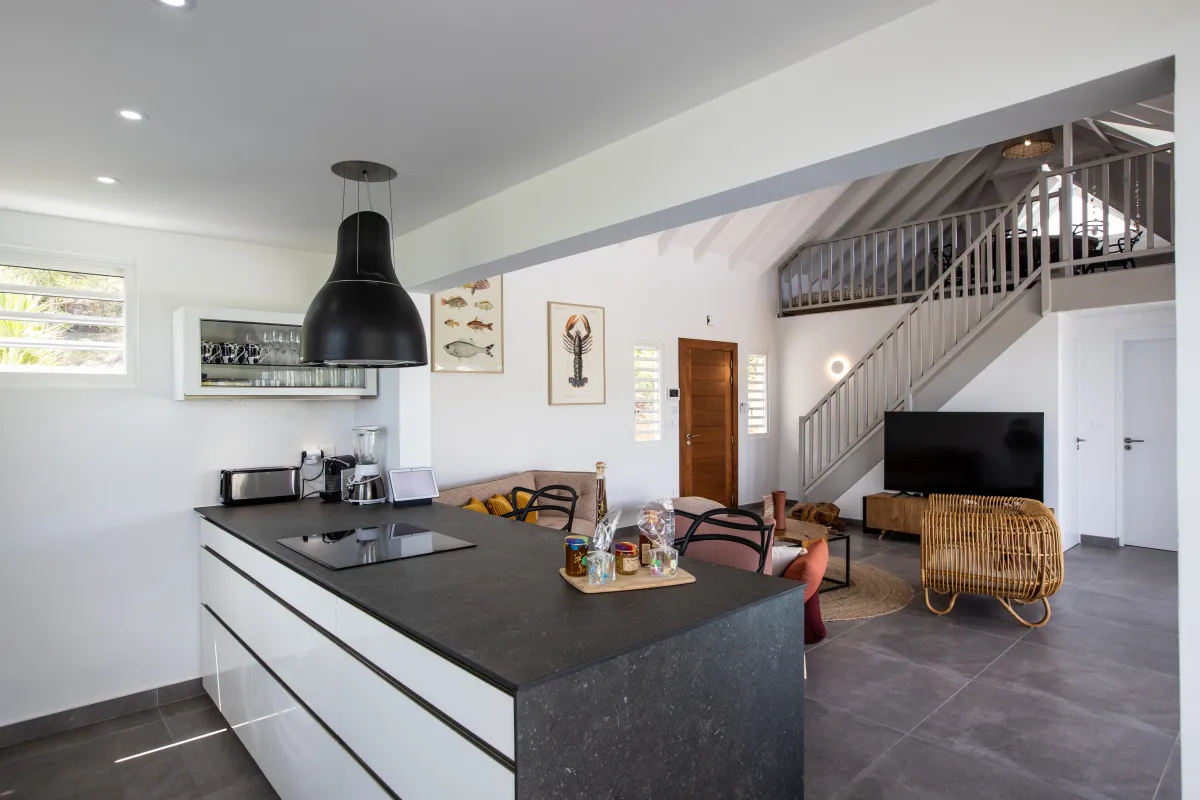 Villa Angelsmart: Open kitchen island and breakfast bar overlooking living room with stairs to a mezzanine