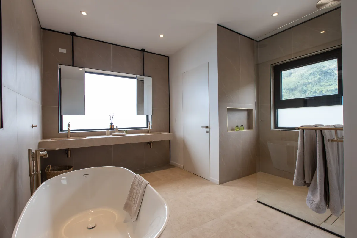 Villa Aqua Dream: Modern bathroom with a freestanding soaking tub, double vanity, and walk-in shower