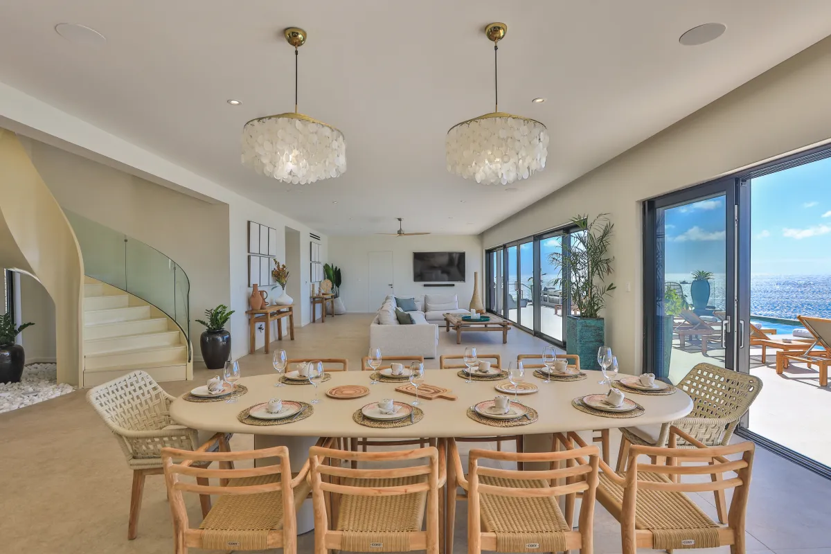 Villa Aqua Dream: Open-concept dining and living area with ocean views and sliding glass doors
