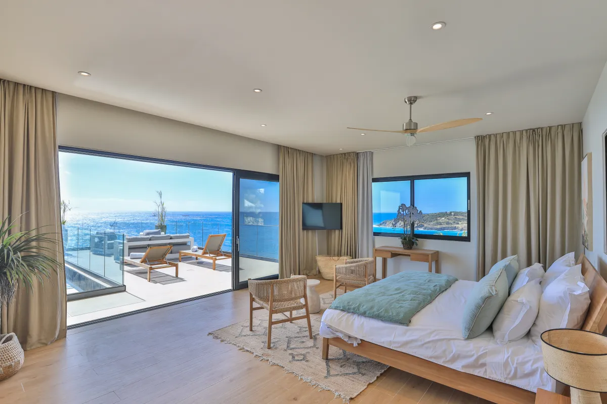 Villa Aqua Dream: Bedroom with king bed opening onto a sunny terrace with ocean views