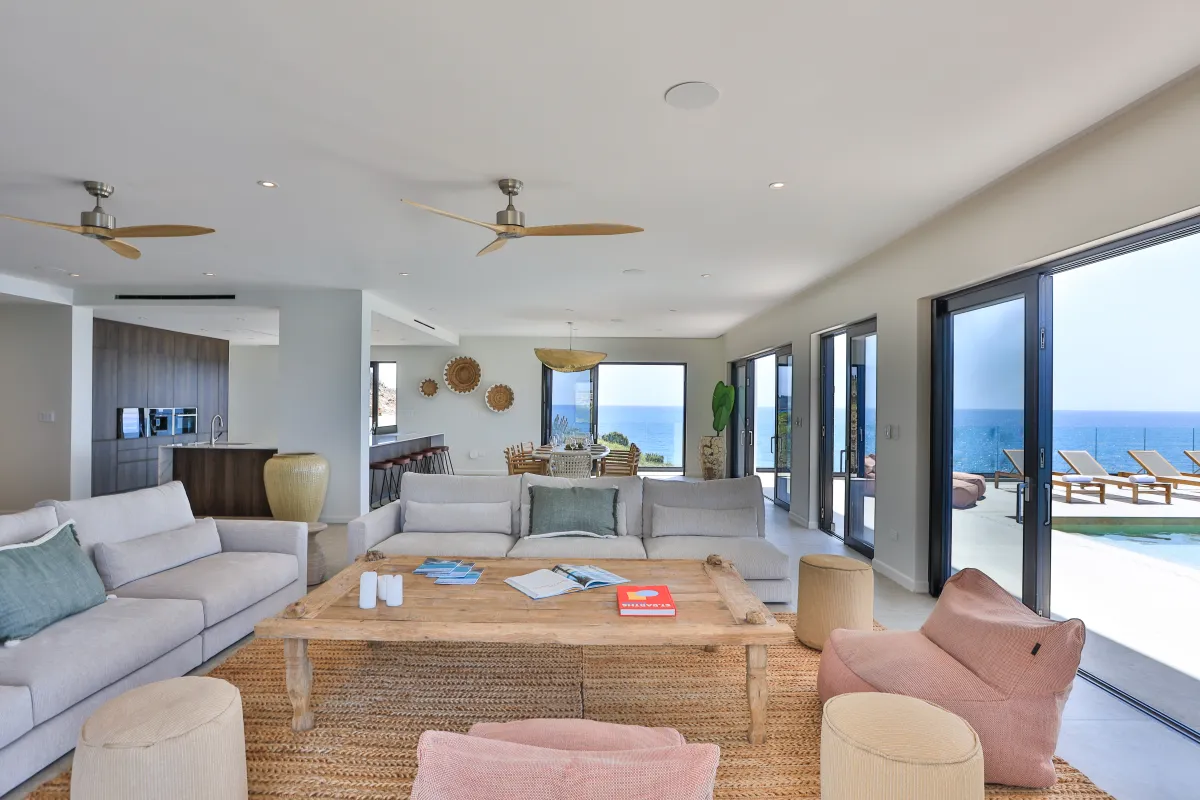 Villa Aqua Vista: Living room with sofas and coffee table opening toward a terrace and ocean views