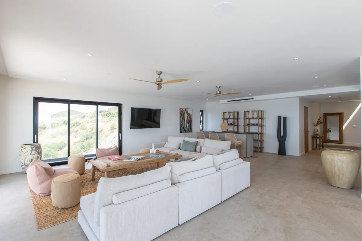 Villa Aqua Vista: Spacious living room with large sectional sofa, coffee table, and sliding glass doors