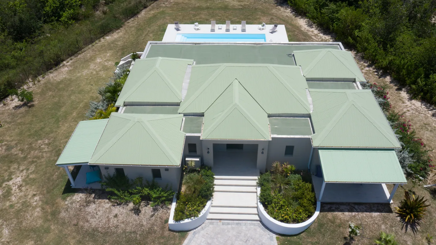 Villa Arawak: Aerial view of a villa with pale green roofs and a backyard swimming pool
