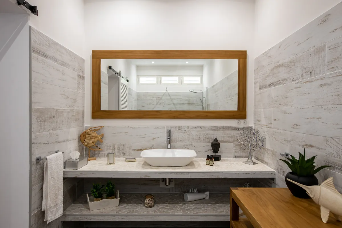 Villa Azur Dream: Bathroom vanity with vessel sink and a large wood framed mirror