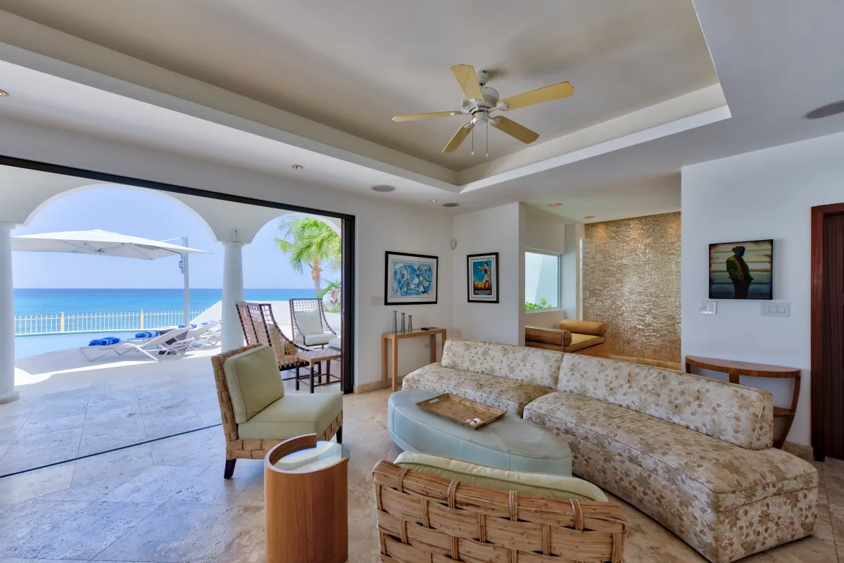 Villa Bahari: Living room with sectional sofa opening to a sun terrace overlooking the ocean