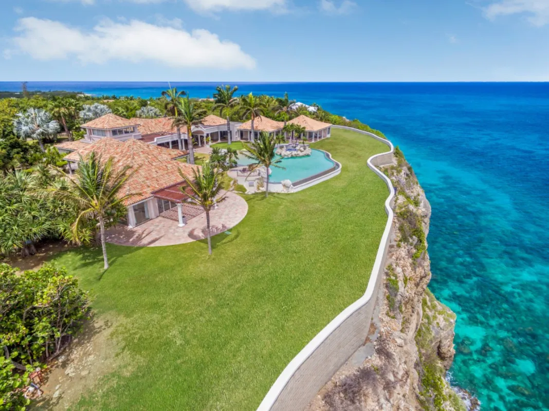 Villa Belle Étoile: Aerial view of a clifftop villa with a pool and manicured lawn overlooking the ocean