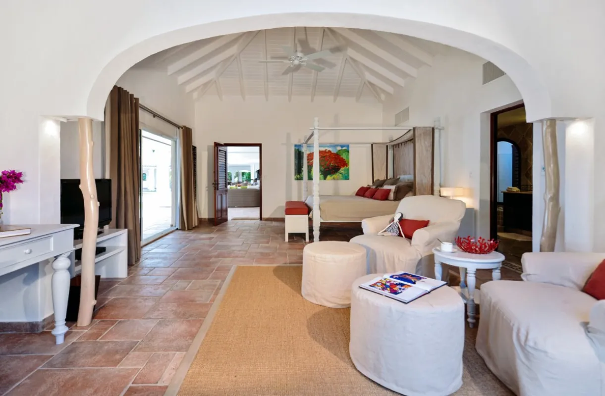 Villa Belle Étoile: Bedroom suite with canopy bed, vaulted ceiling, and sitting area with armchairs