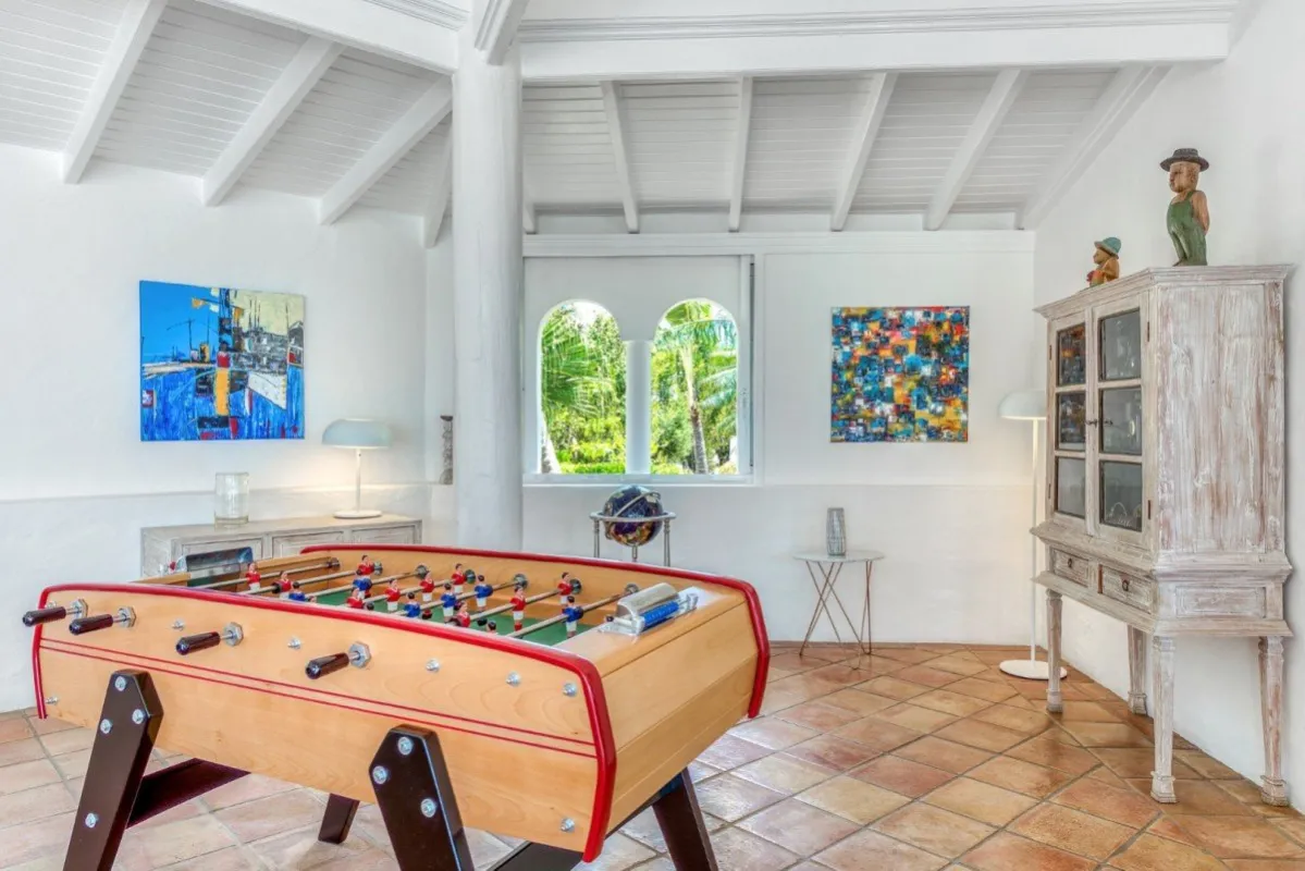 Villa Belle Fontaine: Game room with a foosball table, tiled floor, and beamed ceiling