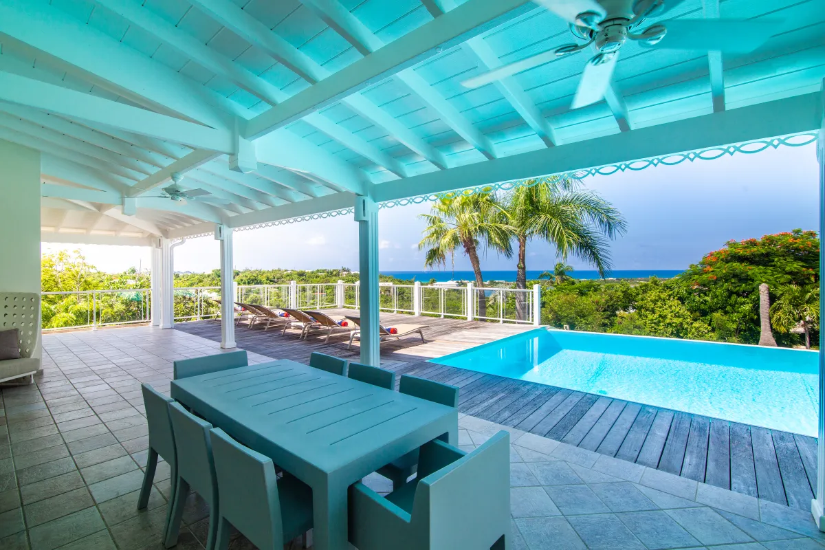 Villa Callisto: Covered terrace with dining table beside a swimming pool and ocean view