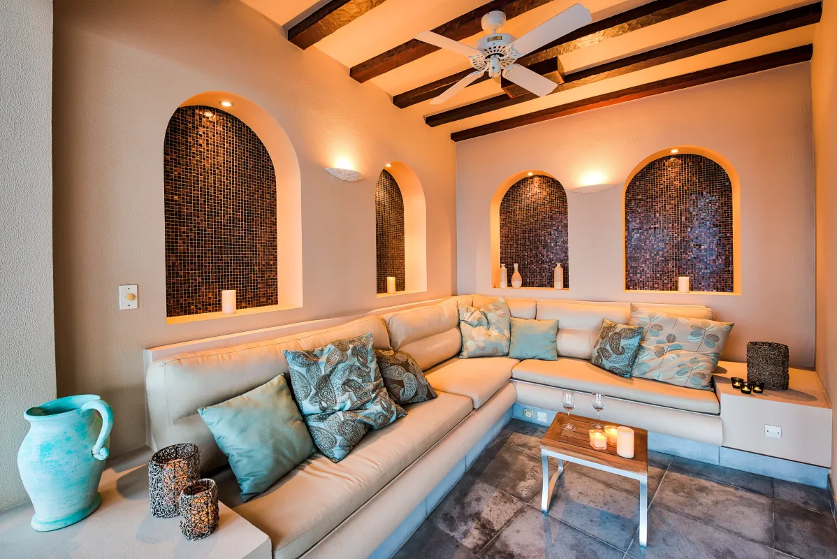 Villa Casa de la Playa: Lounge seating area with a corner sectional sofa and arched mosaic wall niches