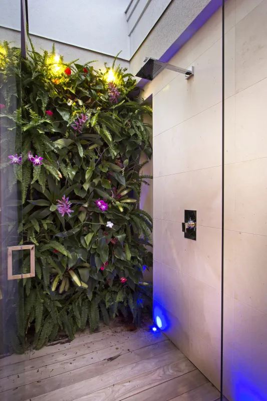Villa C'est la Vie: Outdoor shower area featuring a living plant wall and wood plank flooring