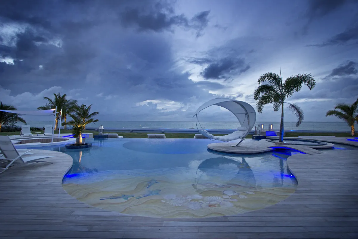Villa C'est la Vie: Custom swimming pool with wooden deck and ocean views under an evening sky
