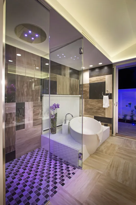 Villa C'est la Vie: Modern bathroom with a glass walk-in shower, freestanding soaking tub, and ambient lighting