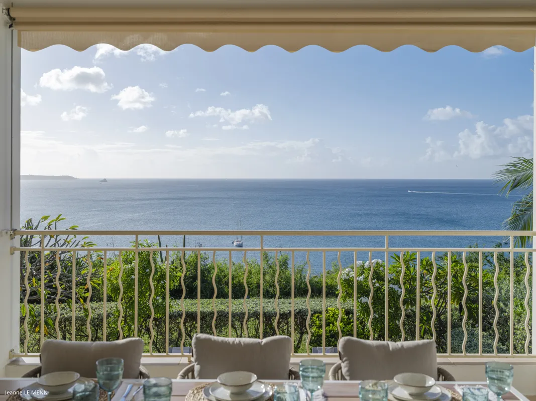 Villa Chez Paulette: Ocean view over balcony railing from an outdoor dining table set for a meal