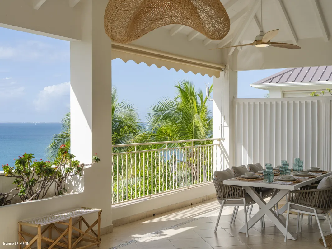 Villa Chez Paulette: Covered terrace with outdoor dining table and chairs overlooking palm trees and the ocean