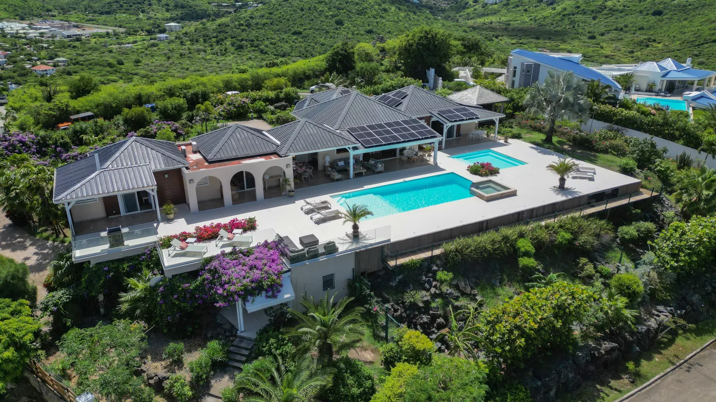 Villa Dreamin Blue: Aerial view of a villa with a swimming pool, spacious sun deck, and tropical hillside