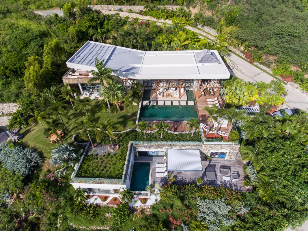 Villa Emeraude: Aerial view of a multi-level villa surrounded by lush tropical landscaping with two swimming pools