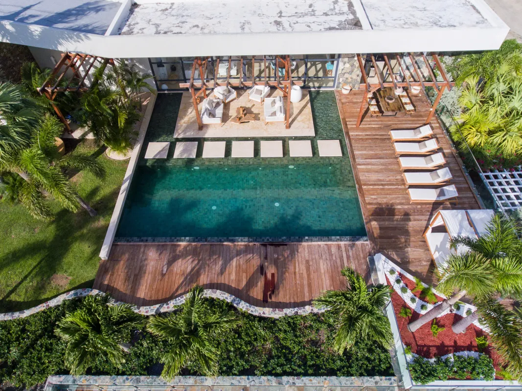 Villa Emeraude: Aerial view of a swimming pool with submerged stepping stones and a wooden sun deck