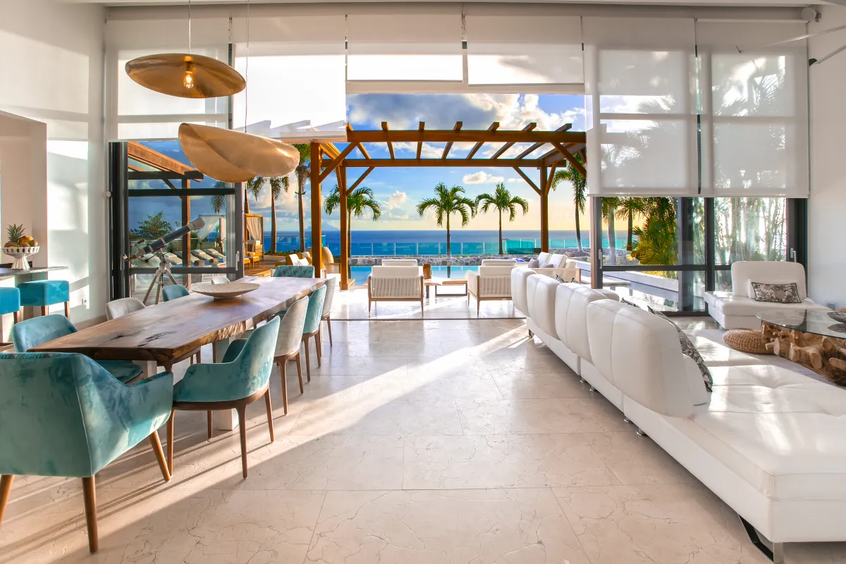 Villa Emeraude: Open-concept living and dining room opening to a covered terrace with ocean views