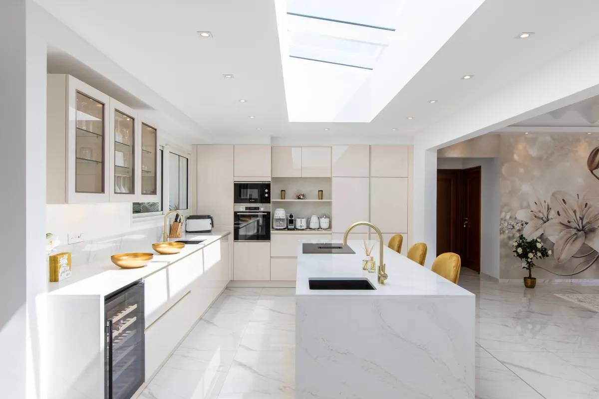 Villa Fleurs de Lys: Bright modern kitchen with skylight, marble island, and gold accents