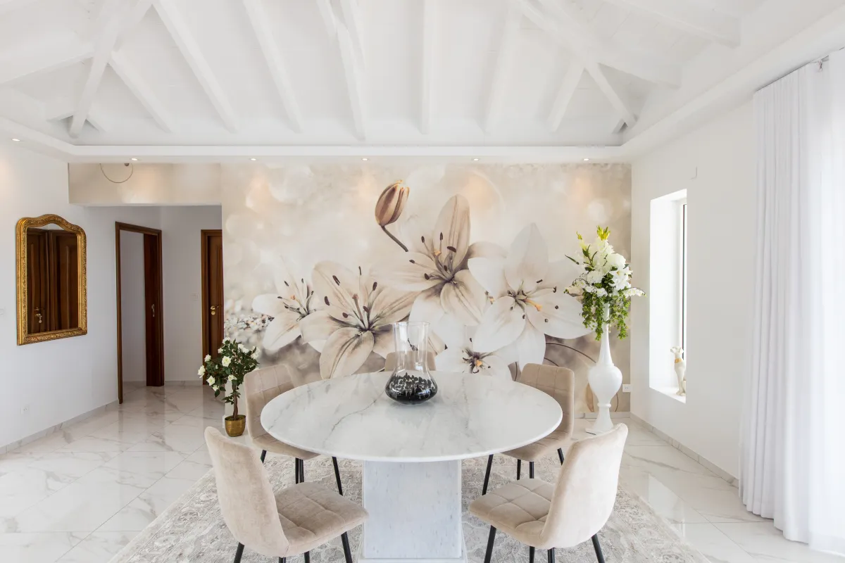 Villa Fleurs de Lys: Round marble dining table and upholstered chairs against a large floral wall mural