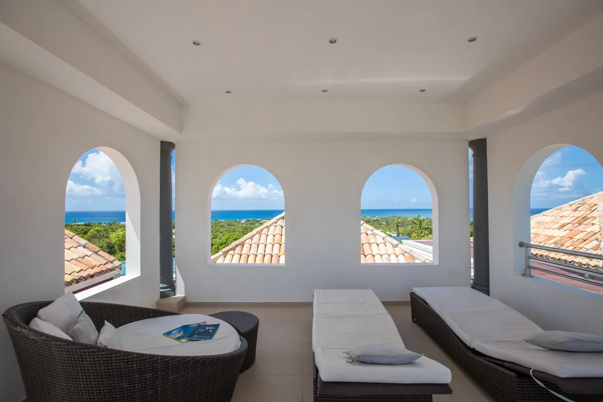 Villa Just in Paradise: Covered terrace with lounge furniture and arched openings overlooking the sea