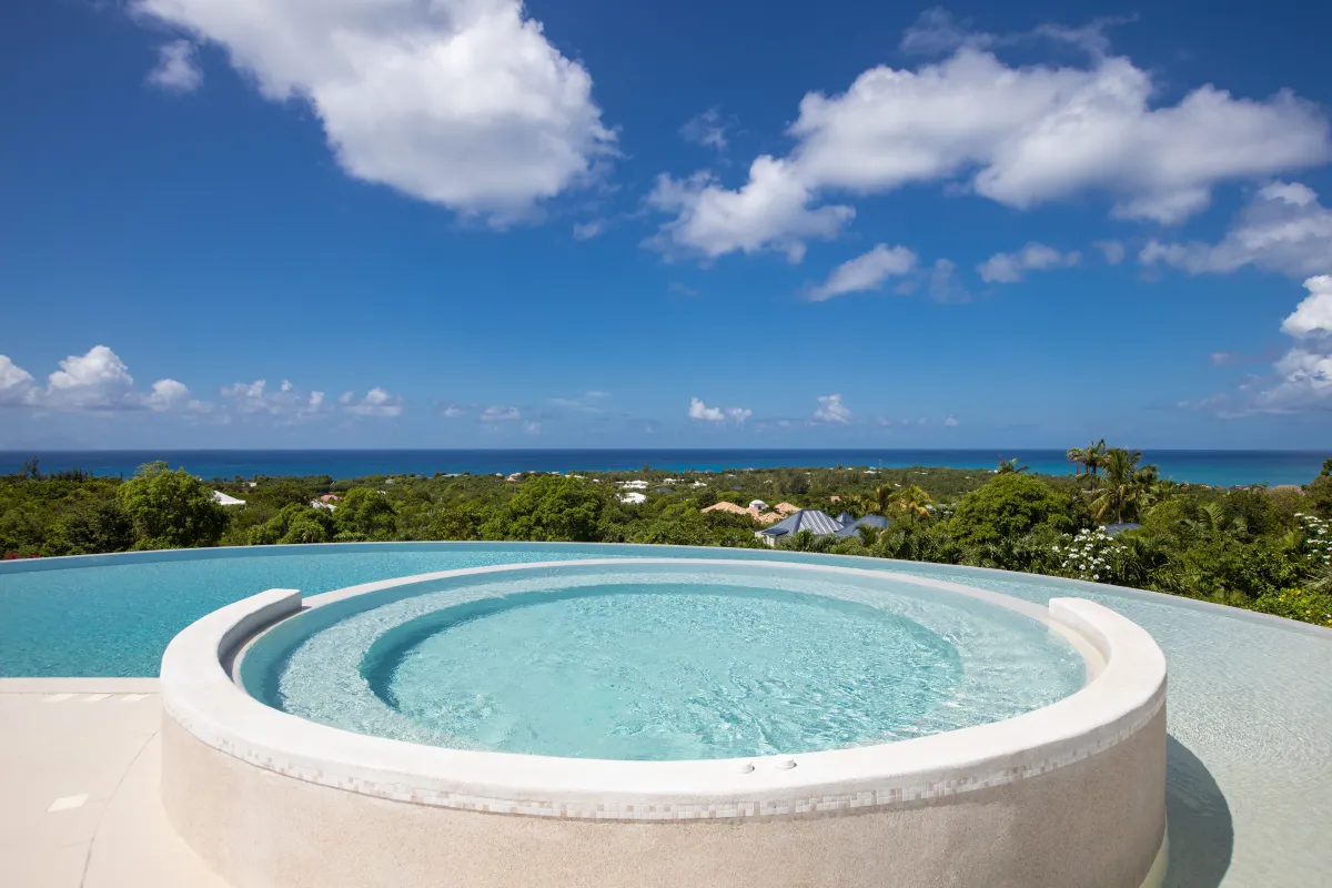 Villa Just in Paradise: Circular hot tub built into an infinity pool overlooking the ocean and green hills