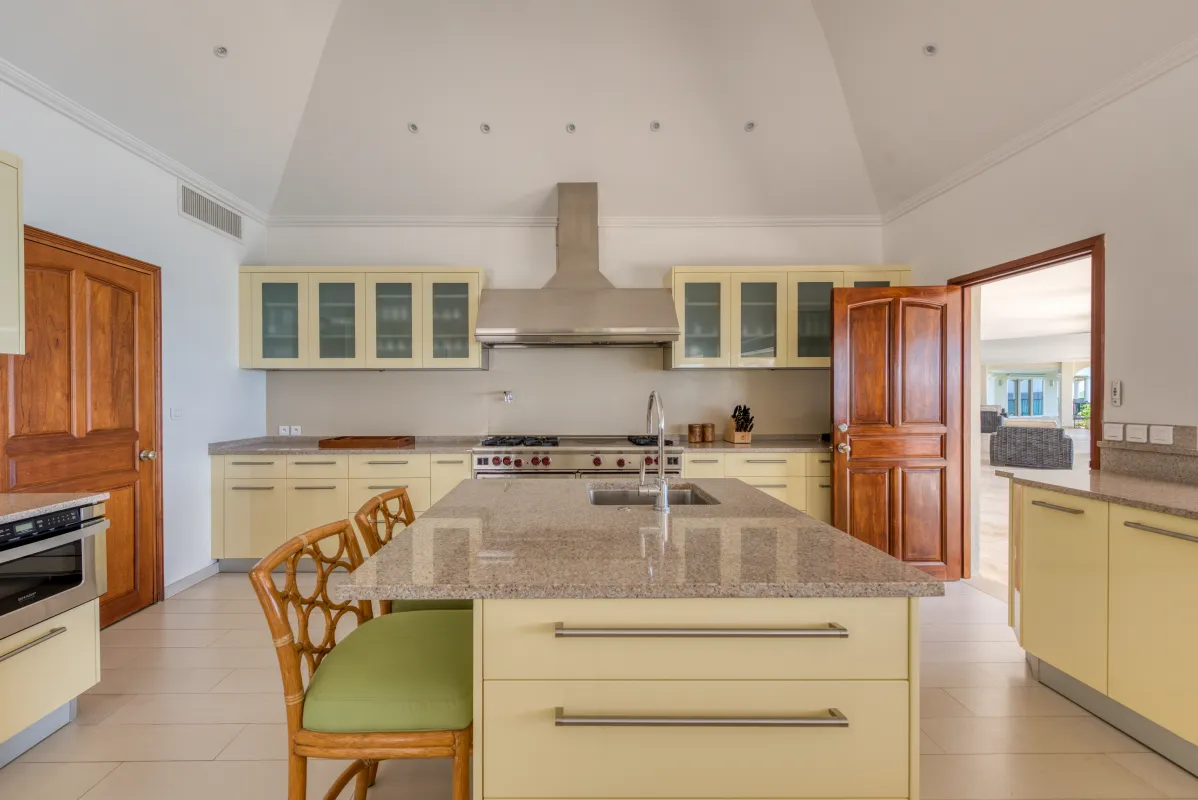 Villa La Dacha: Spacious kitchen with a center island, granite countertops, and light yellow cabinetry