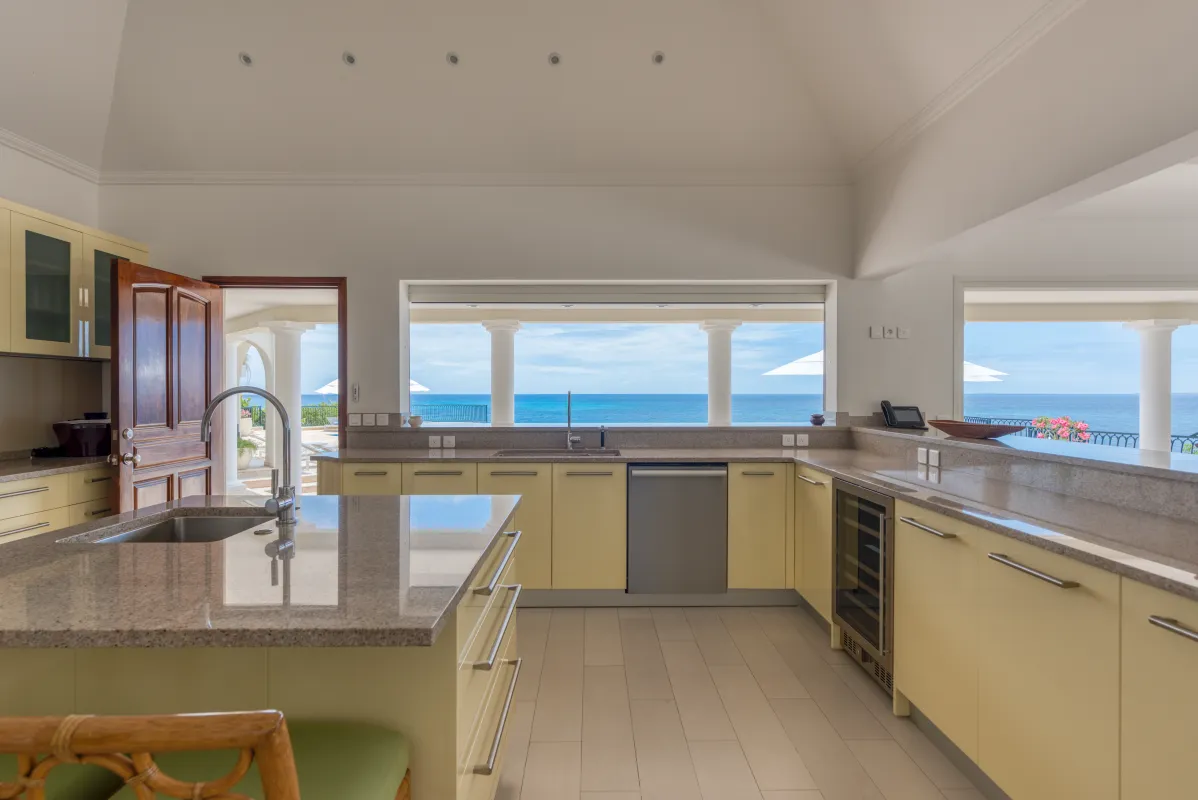 Villa La Dacha: Kitchen with an island and wide window framing a view of the sea