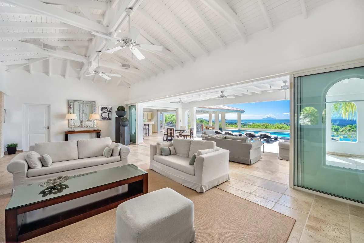Villa La Favorita: Spacious living area opening onto a covered terrace with pool and ocean views
