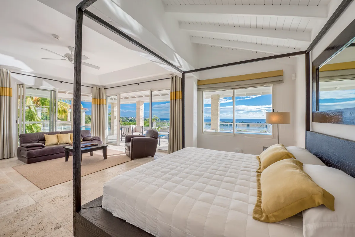 Villa La Favorita: Spacious bedroom suite with four-poster king bed, sitting area, and ocean views