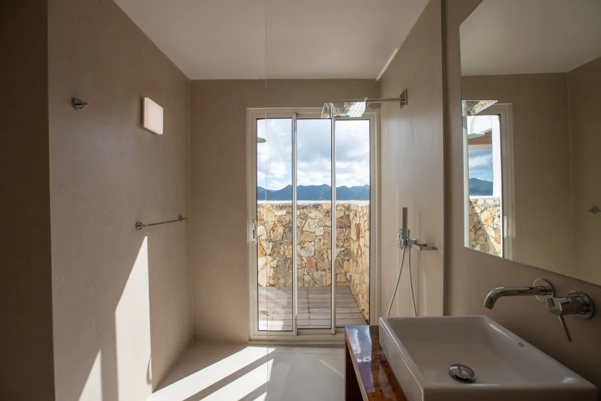 Villa La Siesta: Modern bathroom with walk-in shower and glass door opening to a private patio