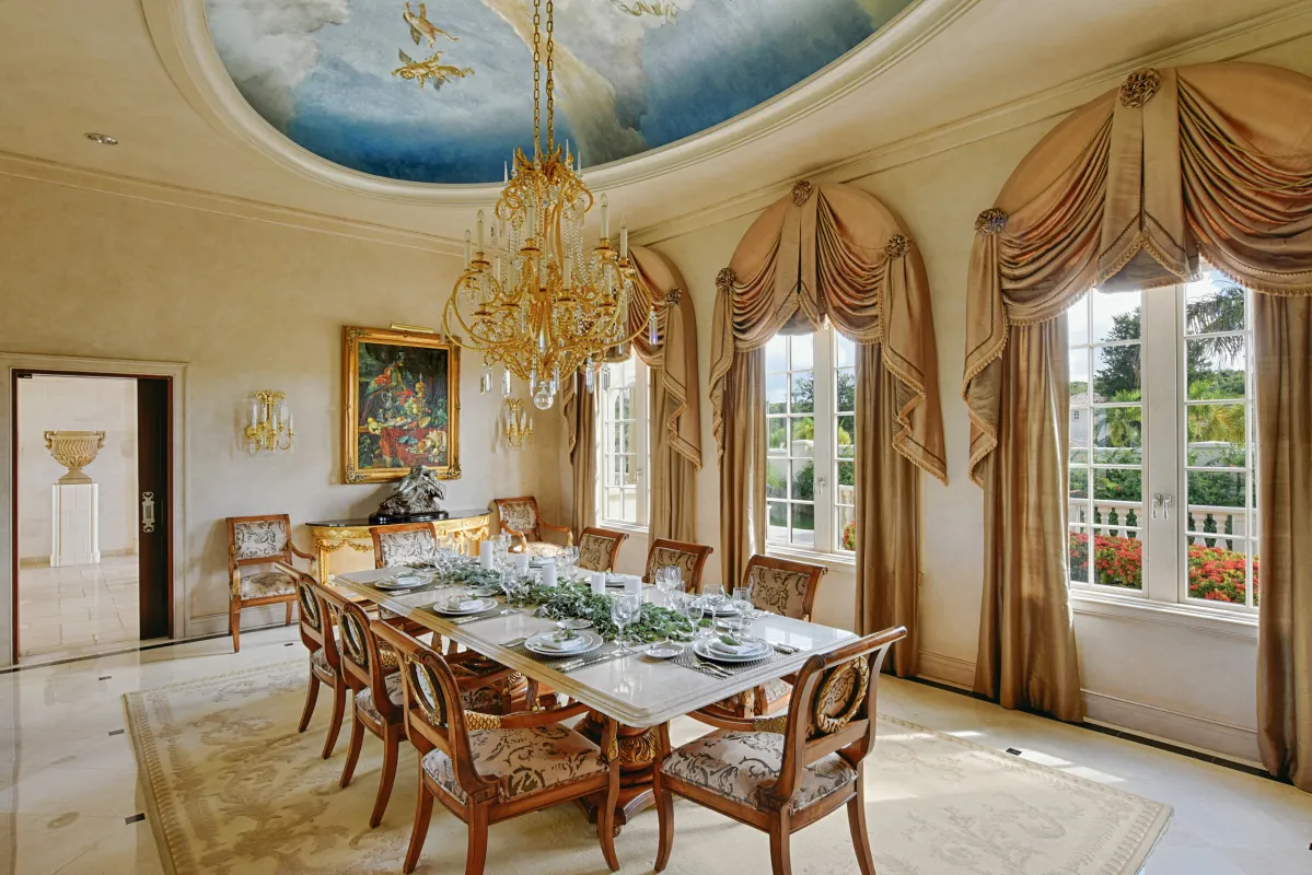 Villa Le Chateau Des Palmiers: Formal dining room featuring a painted ceiling dome, large chandelier, and seated dining table