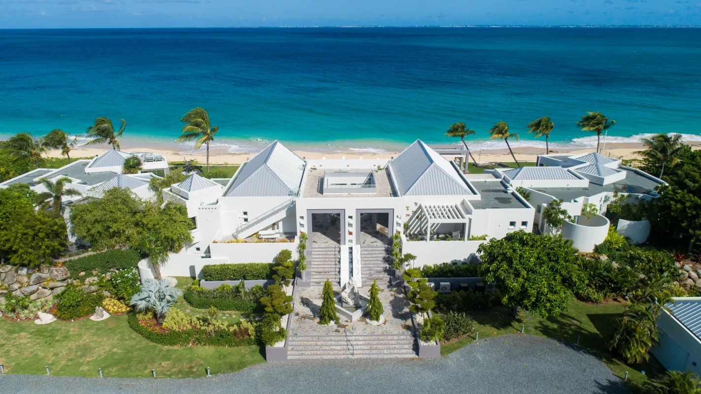 Villa Le Rêve: Aerial view of a beachfront villa compound overlooking turquoise sea and sandy beach