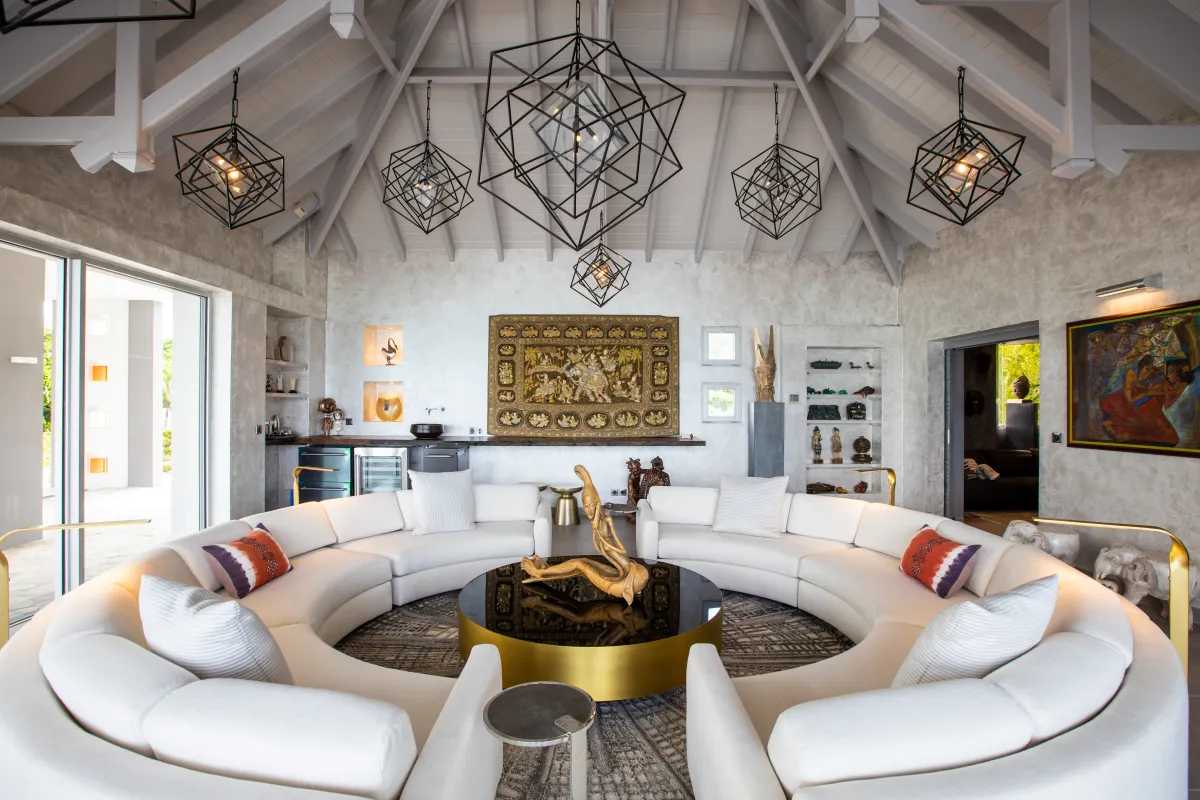 Villa Le Rêve: Spacious living room with large circular sectional sofa and modern geometric chandeliers